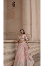 Load image into Gallery viewer, PEACH TAFETTA LEHENGA CHOLI WITH A WORKED BELT AND TULLE DUPATTA