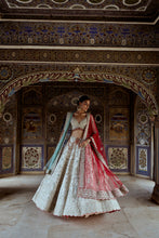 Load image into Gallery viewer, SILVER TISSUE LEHENGA CHOLI SET WITH AQUA NET DUPATTA AND AN OPTIONAL RED NET DUPATTA AND A HEAD VEIL WHICH CAN BE ORDERED SEPARATELY