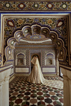 Load image into Gallery viewer, CHAMPAGNE GOLD NET LEHENGA CHOLI AND DUPATTA WITH AN OPTIONAL WORKED BELT AND HEAD VEIL.