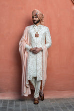 Load image into Gallery viewer, IVORY RAW SILK EMBROIDERED SHERWANI WITH MONGA TASSAR SILK KURTA AND CHURIDAR
