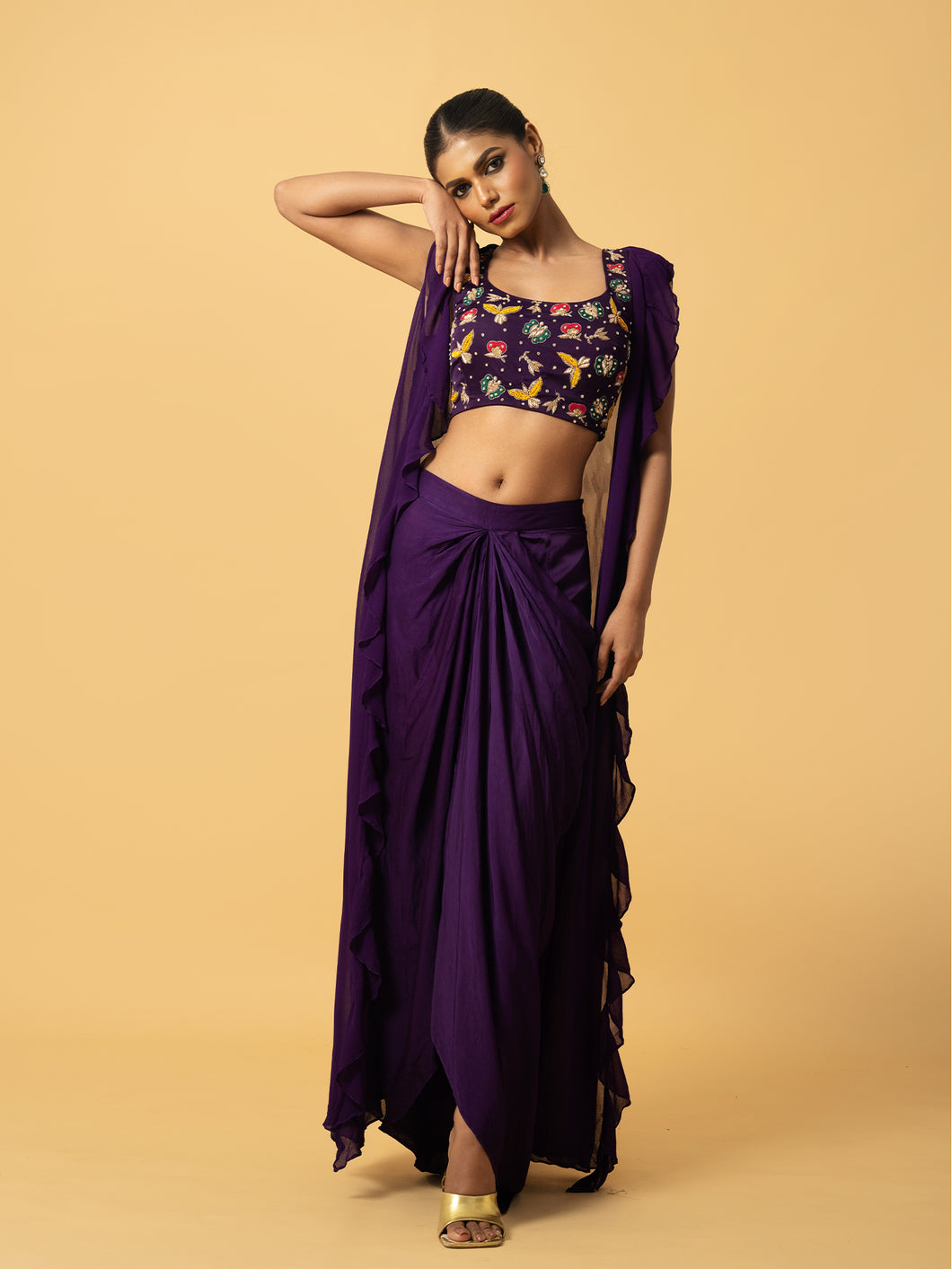Violet Co - ord set with multi coloured hand embroidery on the blouse . Blouse & dhoti is of modal satin , cape is of georgette